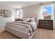 Bright bedroom with neutral tones, featuring a plush bed, modern decor, and natural light at 5455 Baybrook Cir, South Fulton, GA 30349