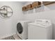 Well-equipped laundry room with modern washer and dryer, shelving for storage, and contemporary design at 5455 Baybrook Cir, South Fulton, GA 30349