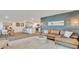 Stylish living room featuring a contemporary design, hardwood floors, and seamless access to the kitchen at 5455 Baybrook Cir, South Fulton, GA 30349