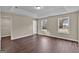 Bright main bedroom features hardwood floors, a tray ceiling, and large windows offering ample natural light at 250 Stonecreek Pkwy, Covington, GA 30016