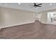 Open floor plan bedroom with a ceiling fan, new wood floors and a doorway to another room at 250 Stonecreek Pkwy, Covington, GA 30016