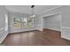 Elegant dining room with hardwood floors, wainscoting, and large windows for natural light at 250 Stonecreek Pkwy, Covington, GA 30016