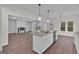 Modern kitchen with white cabinets, granite countertops, stainless steel appliances, and island seating at 250 Stonecreek Pkwy, Covington, GA 30016