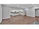 Spacious living area with wood floors and an open floor plan connecting to a modern kitchen at 250 Stonecreek Pkwy, Covington, GA 30016