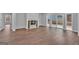 Spacious living room featuring wood floors, a fireplace, and a sliding glass door to the backyard at 250 Stonecreek Pkwy, Covington, GA 30016