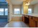 Bathroom with a soaking tub, and cherry-stained wood vanity at 275 Autry Mill Ln, Suwanee, GA 30024