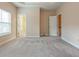Bedroom featuring neutral walls and carpet with an open doorway to the bathroom at 275 Autry Mill Ln, Suwanee, GA 30024