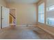 A bedroom with neutral-toned walls, light carpet, and natural light from the window at 275 Autry Mill Ln, Suwanee, GA 30024