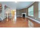 Open living room features hardwood floors, a fireplace, and large windows for natural light at 275 Autry Mill Ln, Suwanee, GA 30024