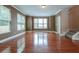 Spacious living room with hardwood floors, crown molding, and large windows with blinds at 275 Autry Mill Ln, Suwanee, GA 30024
