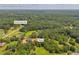 This aerial view showcases the home surrounded by lush greenery and a spacious lot, conveniently located near Smith Store Rd at 676 Smith Store Rd, Covington, GA 30016