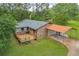 An aerial view of the home with a wooden deck and convenient carport at 676 Smith Store Rd, Covington, GA 30016