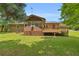 The charming home boasts a spacious wooden deck, screened porch, and lush lawn at 676 Smith Store Rd, Covington, GA 30016