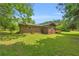 Beautiful backyard with a lawn, mature trees and a screened in porch at 676 Smith Store Rd, Covington, GA 30016