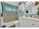 Bright bathroom featuring a white vanity, tub and shower combo with a clear shower curtain at 676 Smith Store Rd, Covington, GA 30016