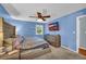 Bedroom with light blue walls, neutral carpet and a ceiling fan at 676 Smith Store Rd, Covington, GA 30016