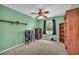 Bedroom featuring light green walls, neutral carpeting and a rustic ceiling fan at 676 Smith Store Rd, Covington, GA 30016