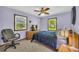 Cozy bedroom features carpet flooring, natural light, and soothing lavender walls for relaxation at 676 Smith Store Rd, Covington, GA 30016