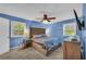 Bedroom with neutral carpet, light blue walls, a ceiling fan and an ensuite at 676 Smith Store Rd, Covington, GA 30016
