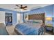 Spacious bedroom with blue walls, a ceiling fan, a closet and an ensuite at 676 Smith Store Rd, Covington, GA 30016