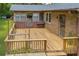 View of the wooden deck with an overhead metal canopy and a door leading indoors at 676 Smith Store Rd, Covington, GA 30016