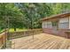 A wooden deck featuring an overhead metal canopy, perfect for outdoor relaxation at 676 Smith Store Rd, Covington, GA 30016