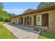 Charming brick home featuring a welcoming entryway with white door, well-manicured lawn, and lovely landscaping details at 676 Smith Store Rd, Covington, GA 30016