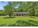 Charming single-story brick home with a well-maintained lawn and mature trees at 676 Smith Store Rd, Covington, GA 30016
