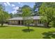 A charming single-story brick house sitting on a well-manicured lawn with mature trees at 676 Smith Store Rd, Covington, GA 30016