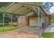 Garage with covered carport and an adjacent deck with gazebo-style roof at 676 Smith Store Rd, Covington, GA 30016