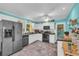 Bright kitchen with stainless steel appliances, white cabinets and tiled floors at 676 Smith Store Rd, Covington, GA 30016