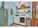 Well-organized laundry room equipped with modern washer and dryer units, storage shelves and rustic decor at 676 Smith Store Rd, Covington, GA 30016