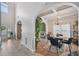 Elegant dining area featuring a herringbone floor, arched doorways, and stylish light fixture at 7530 Springbox Dr, Fairburn, GA 30213
