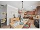 Inviting dining area with open kitchen access and modern lighting at 7530 Springbox Dr, Fairburn, GA 30213