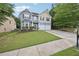 Attractive two-story home with a two-car garage, manicured lawn, and mature trees at 7530 Springbox Dr, Fairburn, GA 30213