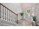 Entryway with stylish wood flooring and a staircase with rod iron balusters at 7530 Springbox Dr, Fairburn, GA 30213