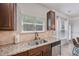 Close up of the kitchen area featuring stainless steel appliances, granite countertops, and window views at 7530 Springbox Dr, Fairburn, GA 30213