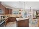 Bright eat-in kitchen with stainless appliances, granite counters, kitchen island, and hardwood flooring at 7530 Springbox Dr, Fairburn, GA 30213