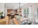 Open kitchen and dining area with hardwood floors, stainless appliances, granite countertops, and a dining table at 7530 Springbox Dr, Fairburn, GA 30213