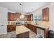 Modern kitchen with stainless appliances, granite countertops, kitchen island, and wooden cabinetry at 7530 Springbox Dr, Fairburn, GA 30213