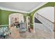 Open-concept living space with archways connecting the dining area and staircase at 7530 Springbox Dr, Fairburn, GA 30213