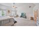 Bright primary bedroom with neutral carpeting, a ceiling fan, chaise lounge, and a television at 7530 Springbox Dr, Fairburn, GA 30213