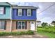 Charming townhome featuring a blue exterior, brick accents, manicured lawn, and a welcoming white front door at 128 Evergreen Trl # 4, Cartersville, GA 30121