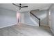 Open living room with gray floors, stairs, and bathroom view showcasing a bright, modern design at 128 Evergreen Trl # 4, Cartersville, GA 30121