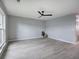 Bright living room with gray floors, a modern ceiling fan, and neutral paint that create a calming ambiance at 128 Evergreen Trl # 4, Cartersville, GA 30121
