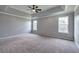 This main bedroom features tray ceilings, fresh gray paint and a ceiling fan at 128 Evergreen Trl # 4, Cartersville, GA 30121