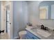 This powder room features a blue vanity with a marble countertop at 128 Evergreen Trl # 4, Cartersville, GA 30121