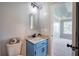 This powder room features a blue vanity with a marble countertop and modern light fixtures at 128 Evergreen Trl # 4, Cartersville, GA 30121