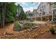 Gorgeous backyard with an in-ground pool, covered porch, and a meticulously landscaped yard at 165 Ansley Way, Roswell, GA 30075