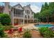 Expansive backyard featuring an in-ground pool, hot tub, fire pit, and outdoor seating at 165 Ansley Way, Roswell, GA 30075